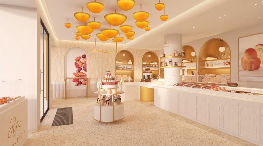 Krémový interiér butiku Ritz Paris Le Comptoir Sèvres s obloukovými nikami a oranžovými svítidly