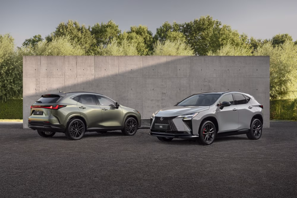 Dva nové vozy Lexus NX zaparkované vedle sebe před moderní budovou